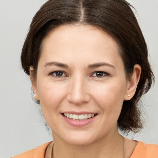 Joyful white young-adult female with medium  brown hair and brown eyes