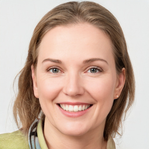 Joyful white young-adult female with medium  brown hair and blue eyes