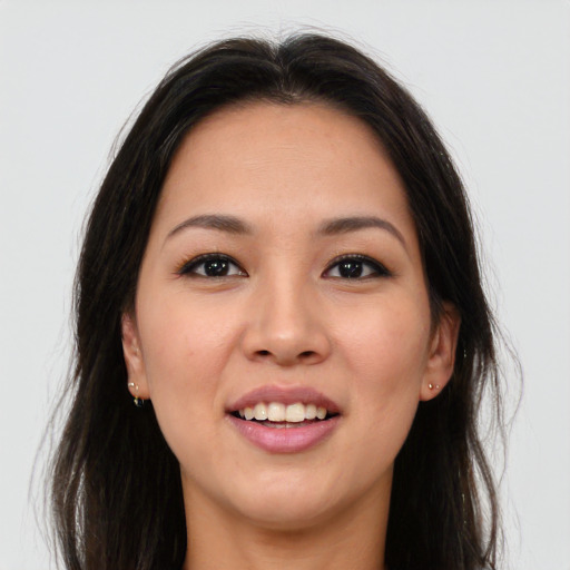 Joyful asian young-adult female with long  brown hair and brown eyes