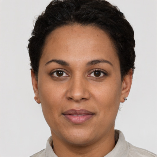Joyful latino adult female with short  black hair and brown eyes