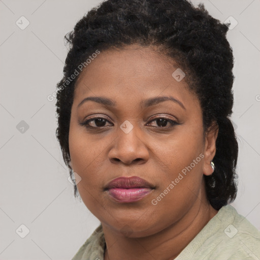 Joyful black adult female with short  brown hair and brown eyes