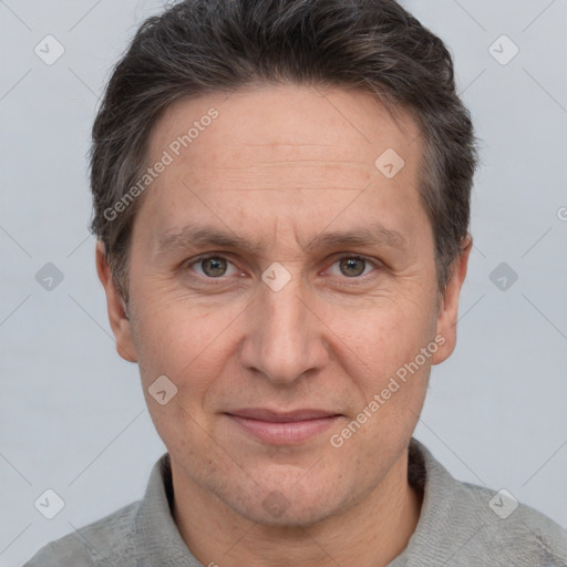 Joyful white adult male with short  brown hair and grey eyes