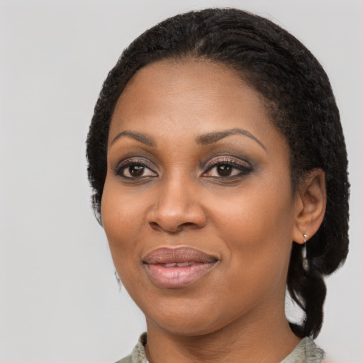 Joyful black adult female with medium  black hair and brown eyes
