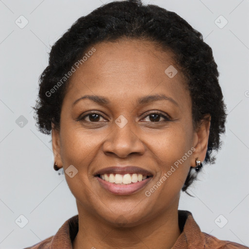 Joyful black adult female with short  brown hair and brown eyes