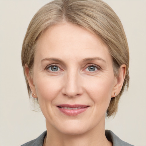 Joyful white adult female with medium  brown hair and grey eyes