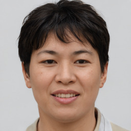 Joyful asian young-adult female with short  brown hair and brown eyes