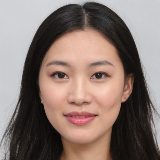 Joyful asian young-adult female with long  brown hair and brown eyes