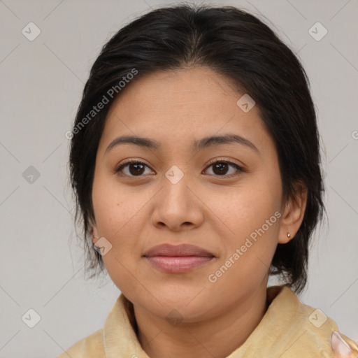 Joyful latino young-adult female with medium  brown hair and brown eyes