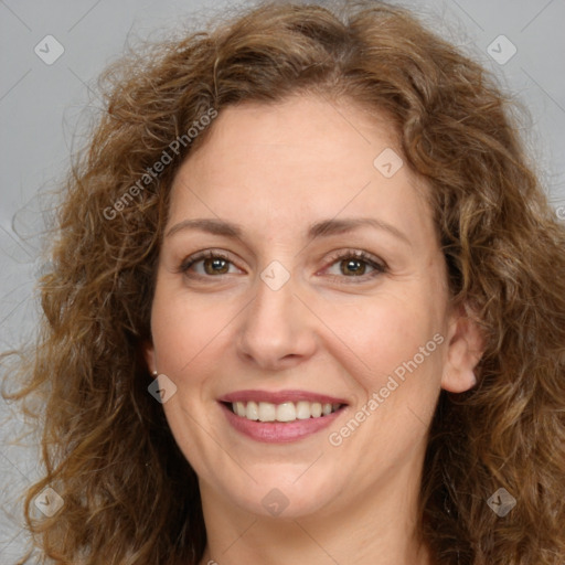 Joyful white adult female with long  brown hair and brown eyes