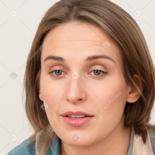 Joyful white young-adult female with medium  brown hair and blue eyes