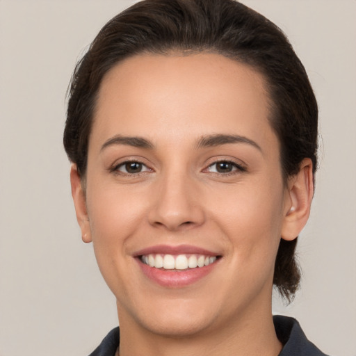 Joyful white young-adult female with short  brown hair and brown eyes