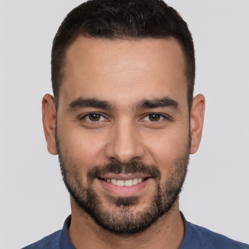 Joyful white young-adult male with short  black hair and brown eyes