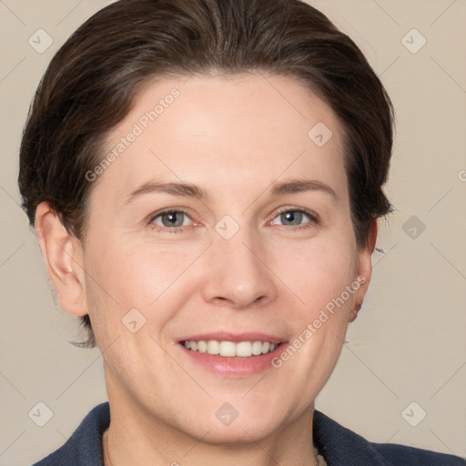 Joyful white adult female with short  brown hair and grey eyes