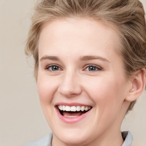 Joyful white young-adult female with medium  brown hair and blue eyes