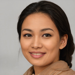 Joyful asian young-adult female with long  brown hair and brown eyes