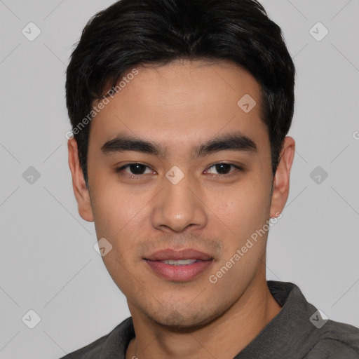 Joyful asian young-adult male with short  black hair and brown eyes