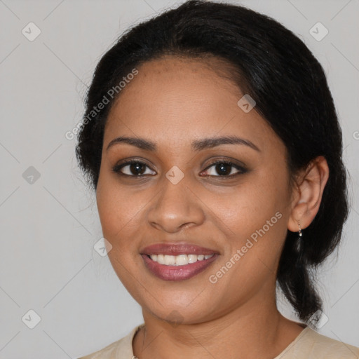 Joyful black young-adult female with medium  black hair and brown eyes