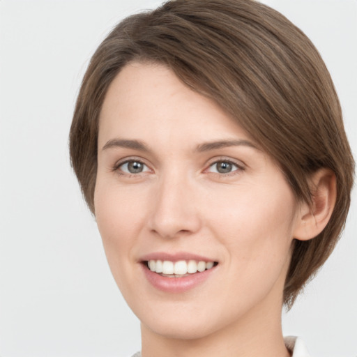 Joyful white young-adult female with medium  brown hair and green eyes