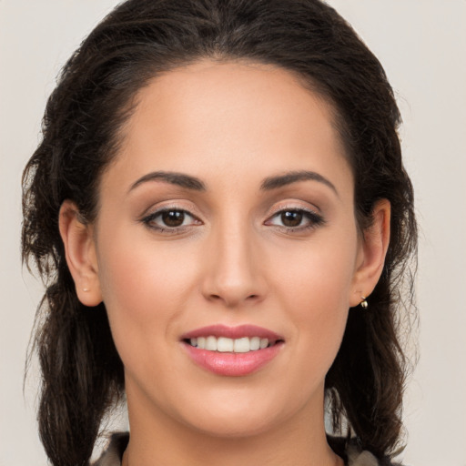 Joyful white young-adult female with long  brown hair and brown eyes