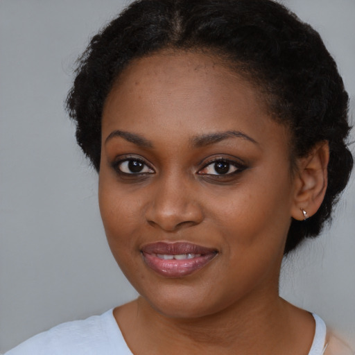 Joyful black young-adult female with medium  brown hair and brown eyes