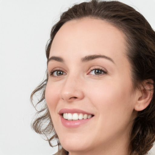 Joyful white young-adult female with long  brown hair and green eyes