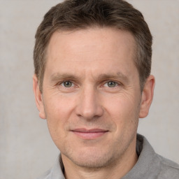 Joyful white adult male with short  brown hair and grey eyes