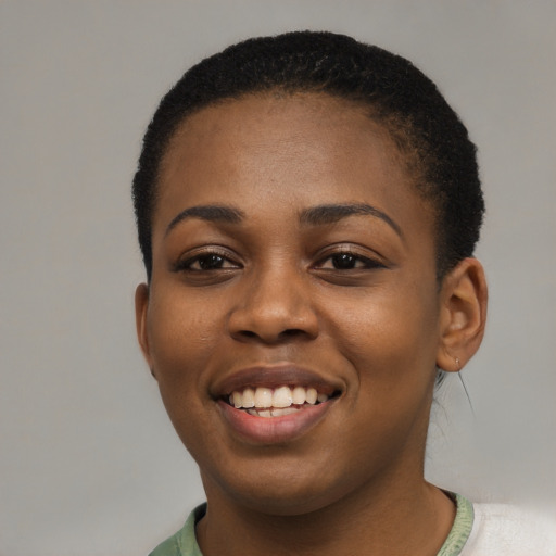 Joyful black young-adult female with short  black hair and brown eyes