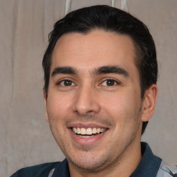 Joyful white young-adult male with short  black hair and brown eyes