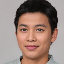 Joyful asian young-adult male with short  brown hair and brown eyes