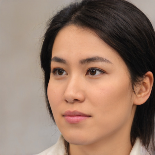 Neutral asian young-adult female with medium  brown hair and brown eyes