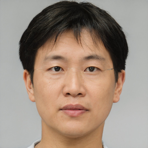 Neutral asian adult male with short  brown hair and brown eyes