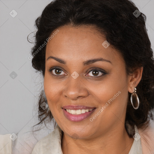 Joyful black young-adult female with long  brown hair and brown eyes