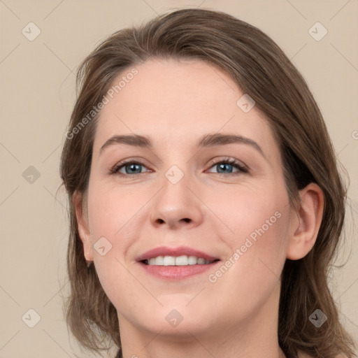 Joyful white young-adult female with medium  brown hair and green eyes