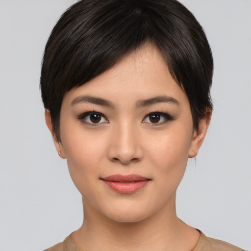 Joyful asian young-adult female with short  black hair and brown eyes