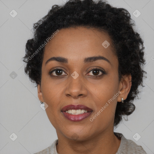 Joyful black young-adult female with short  brown hair and brown eyes