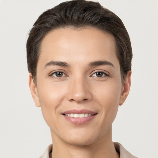 Joyful white young-adult female with short  brown hair and brown eyes