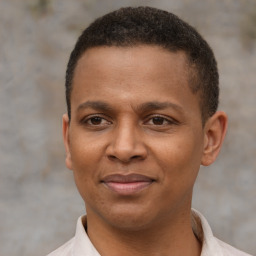 Joyful latino young-adult male with short  brown hair and brown eyes