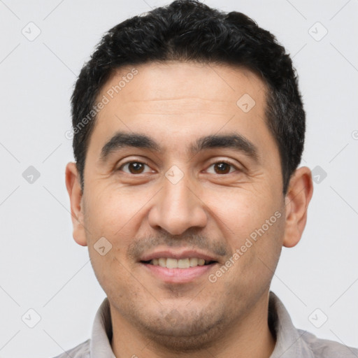Joyful latino young-adult male with short  black hair and brown eyes