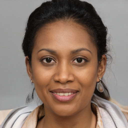 Joyful black young-adult female with long  brown hair and brown eyes