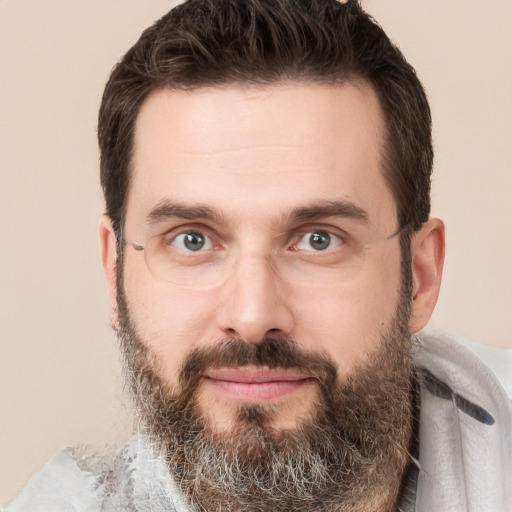 Joyful white adult male with short  brown hair and brown eyes