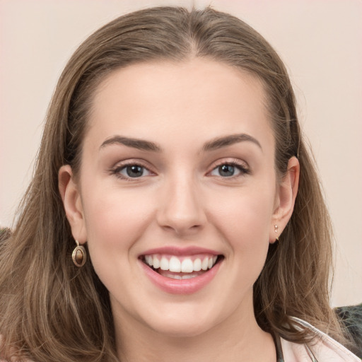 Joyful white young-adult female with long  brown hair and grey eyes