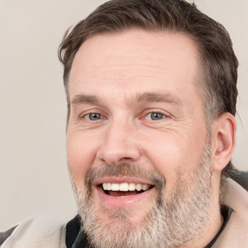 Joyful white adult male with short  brown hair and grey eyes