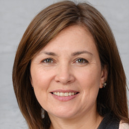 Joyful white adult female with medium  brown hair and grey eyes