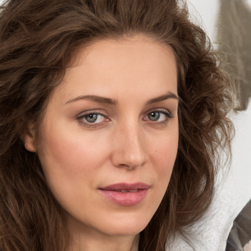 Joyful white young-adult female with long  brown hair and grey eyes