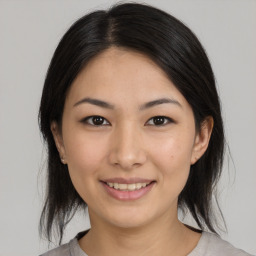 Joyful asian young-adult female with medium  brown hair and brown eyes