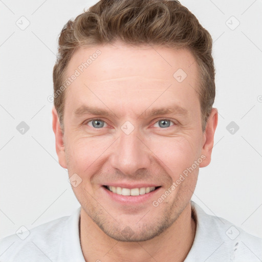 Joyful white adult male with short  brown hair and grey eyes