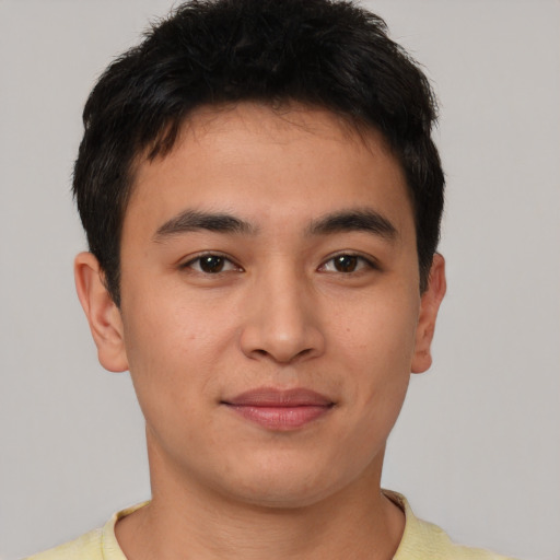 Joyful asian young-adult male with short  brown hair and brown eyes