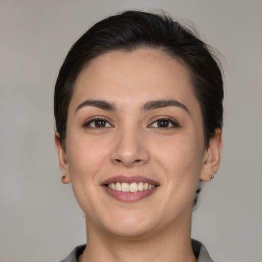 Joyful white young-adult female with short  brown hair and brown eyes