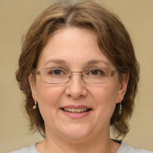 Joyful white adult female with medium  brown hair and green eyes