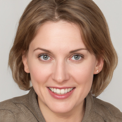 Joyful white young-adult female with medium  brown hair and blue eyes